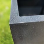 Coated steel planter box on a grassy background