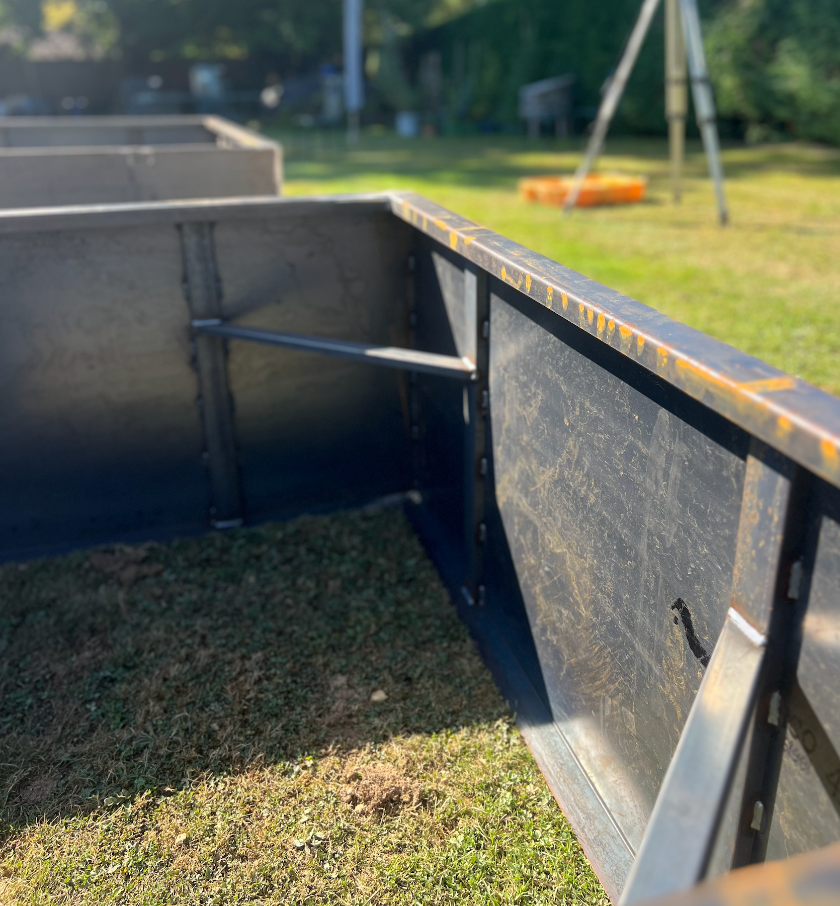Metal storage unit on grass with a blurred background