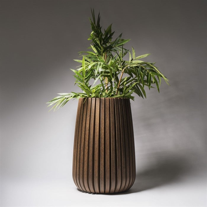 Wooden planter with a plant on a gray background