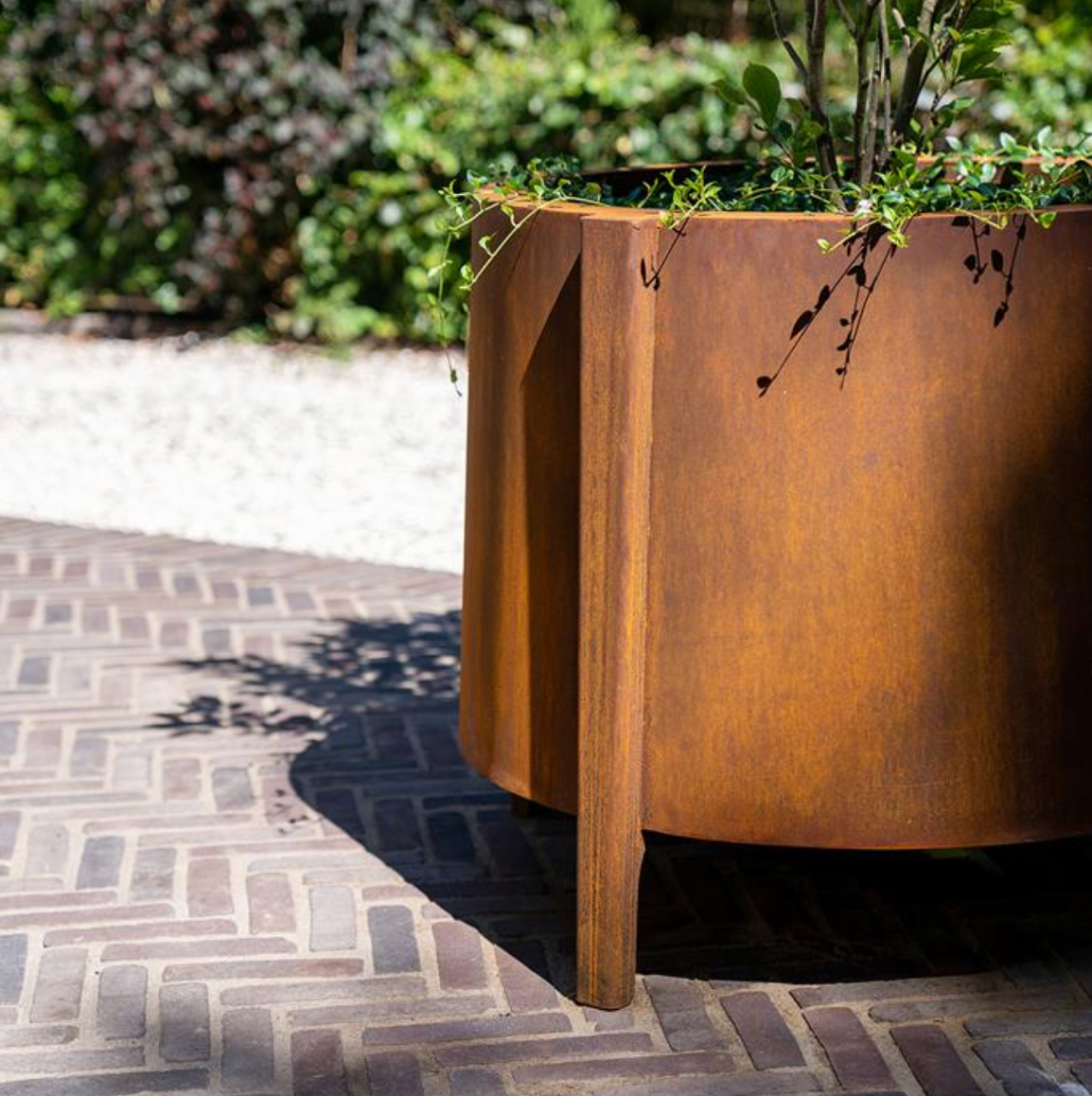 large corten steel round planter with feet