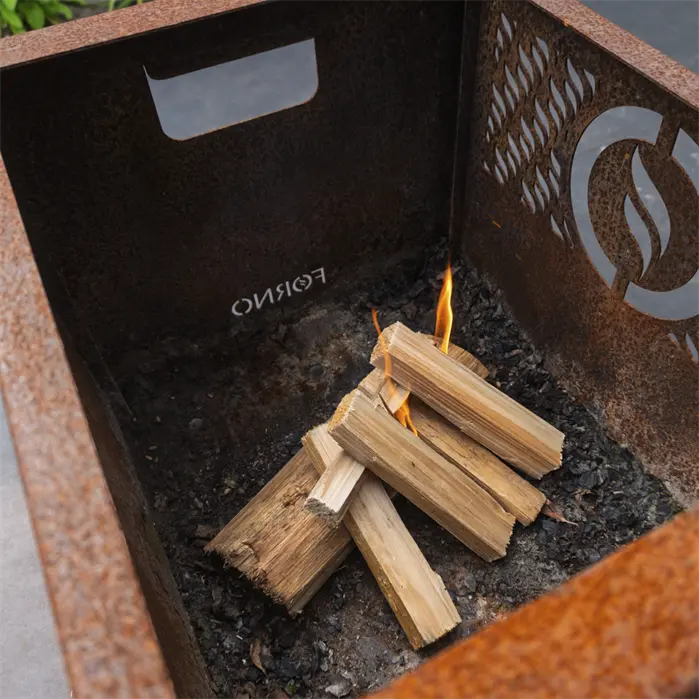 Firewood in a metal fire pit with 'Forno' branding.