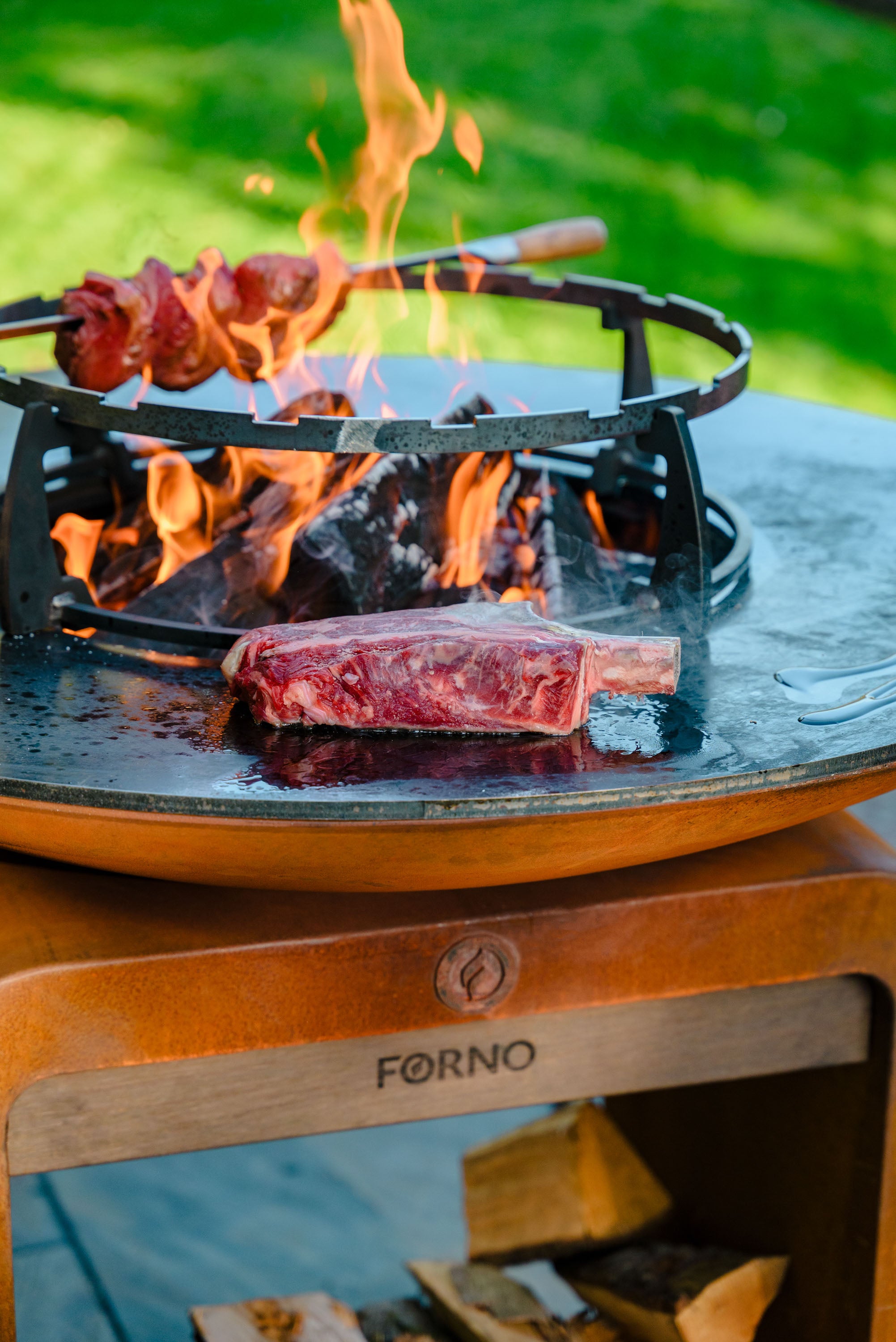 Grill with food being cooked over an open flame outdoors