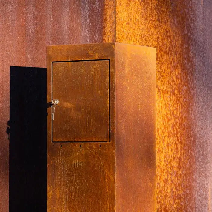 corten letterbox with key in it set against a corten panel