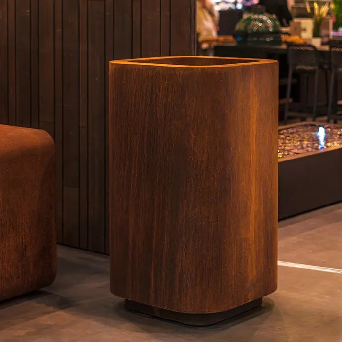 designer tall corten steel garden planter by Adezz without plants in it and placed inside