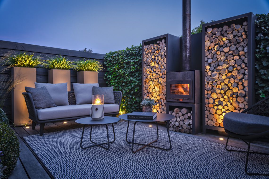 large wood storage surrounding outdoor stove