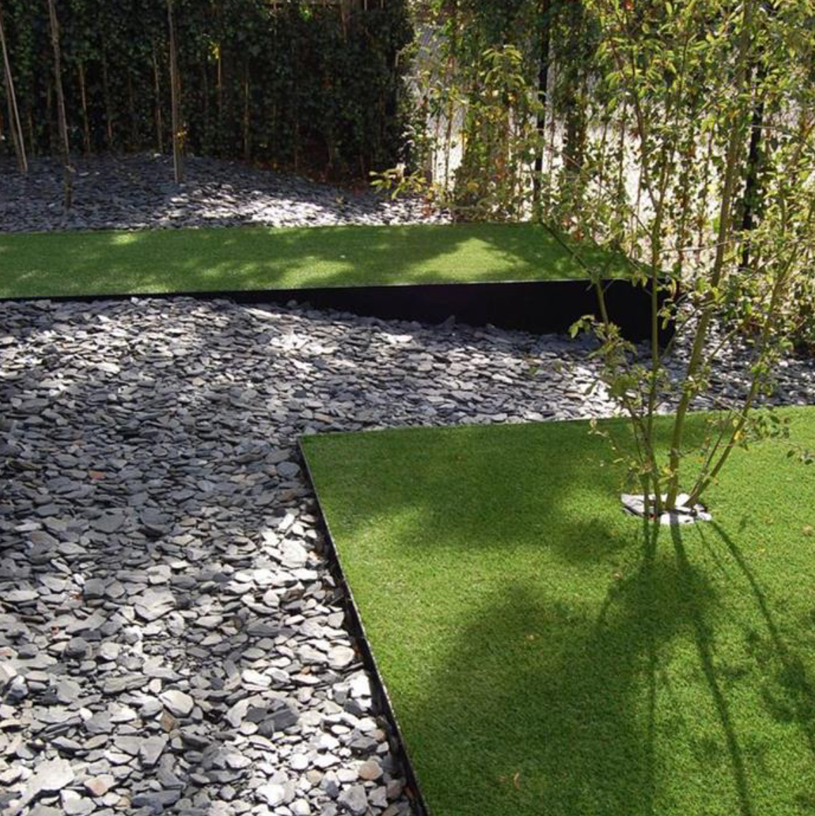 garden edging in folded corten steel either side of stone path
