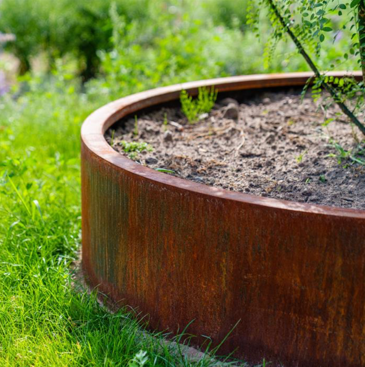 detail of a round raised corten steel garden bed