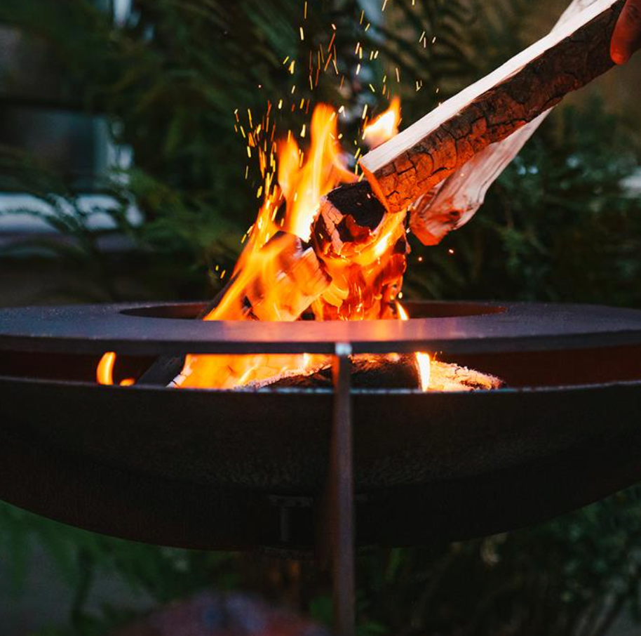 lit bbq fire table with flaming wood