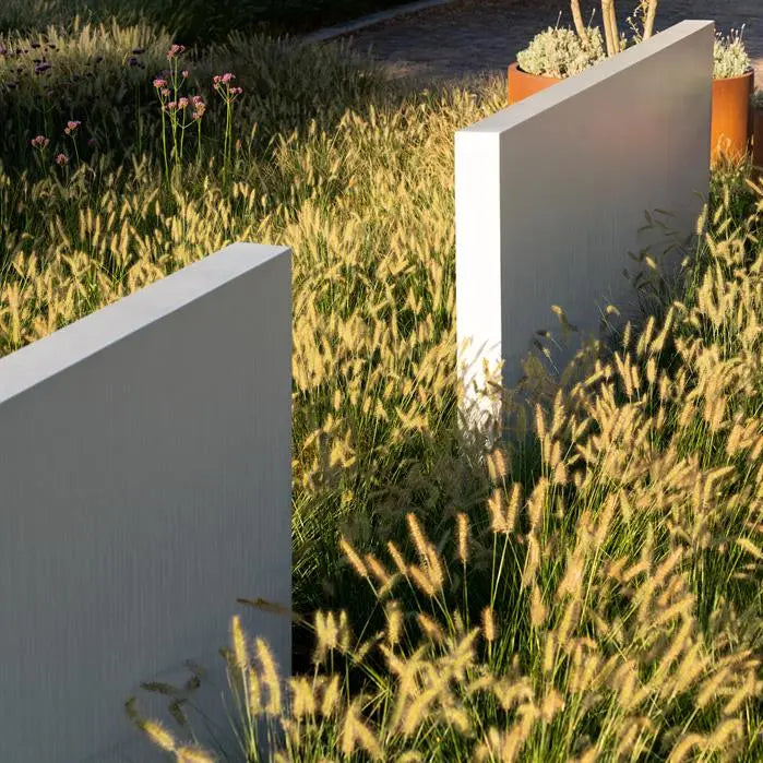 two white fiberglass walls set in grass