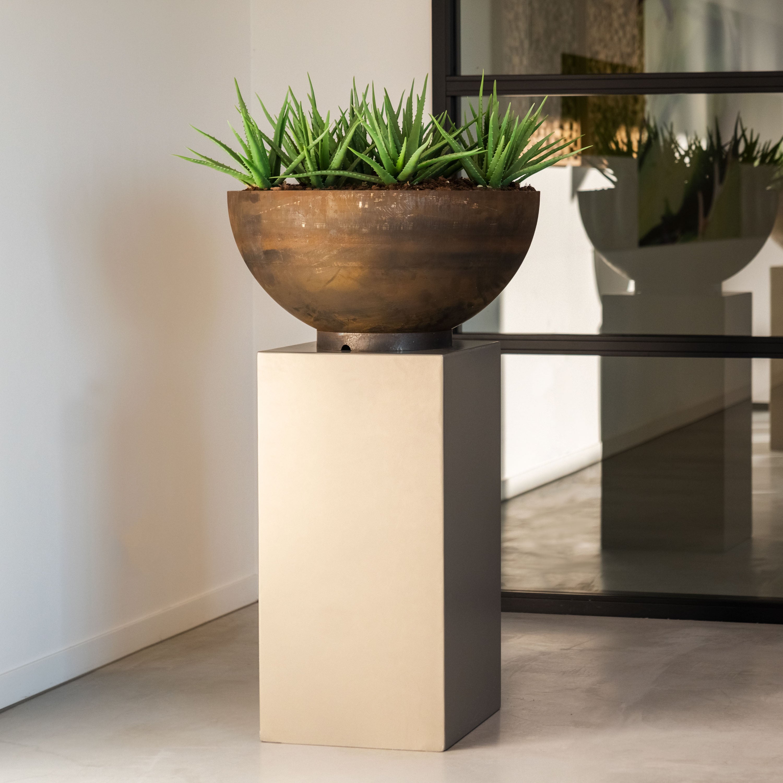 Decorative plant in a bowl on a pedestal in a modern interior setting