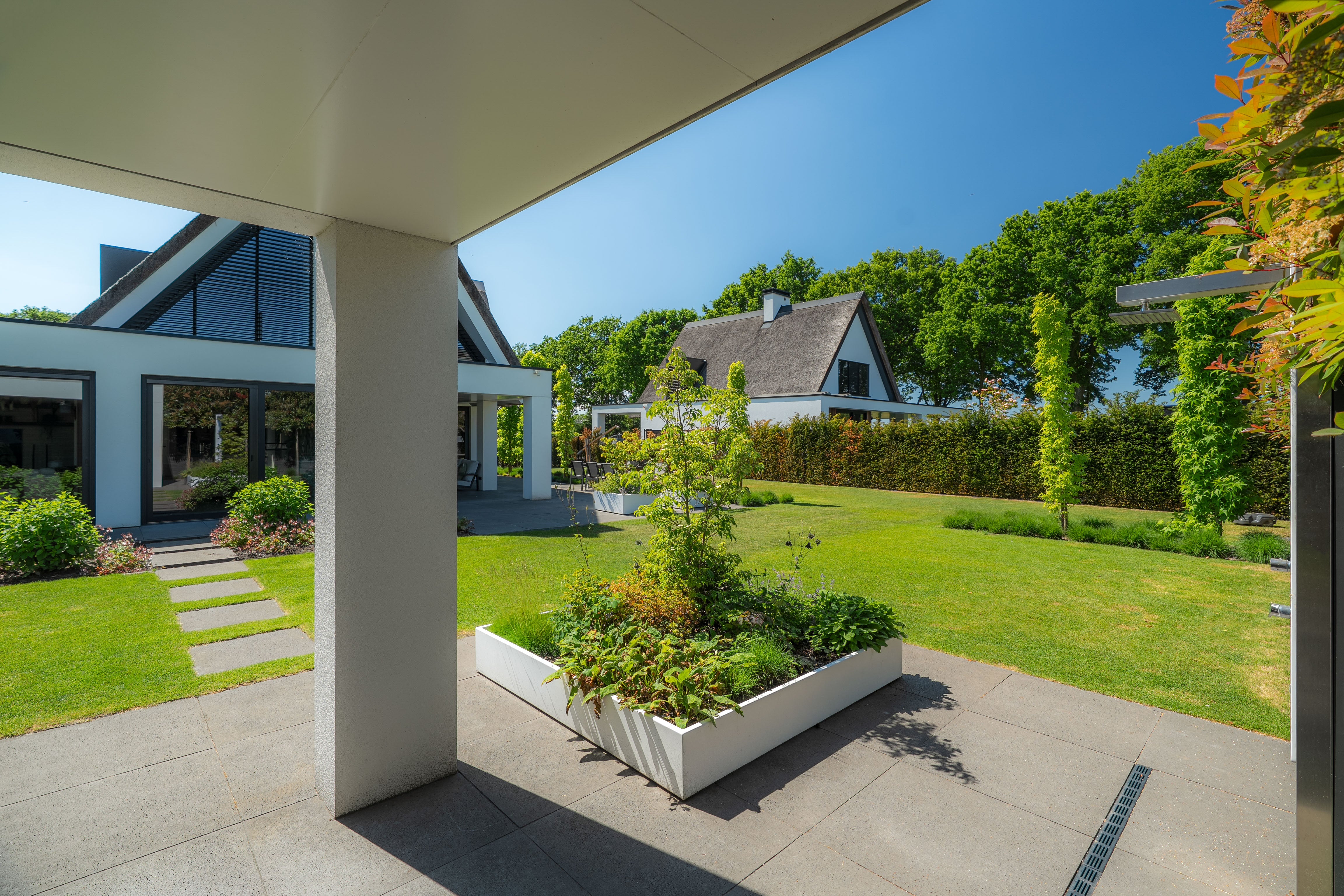 white  square planter in garden