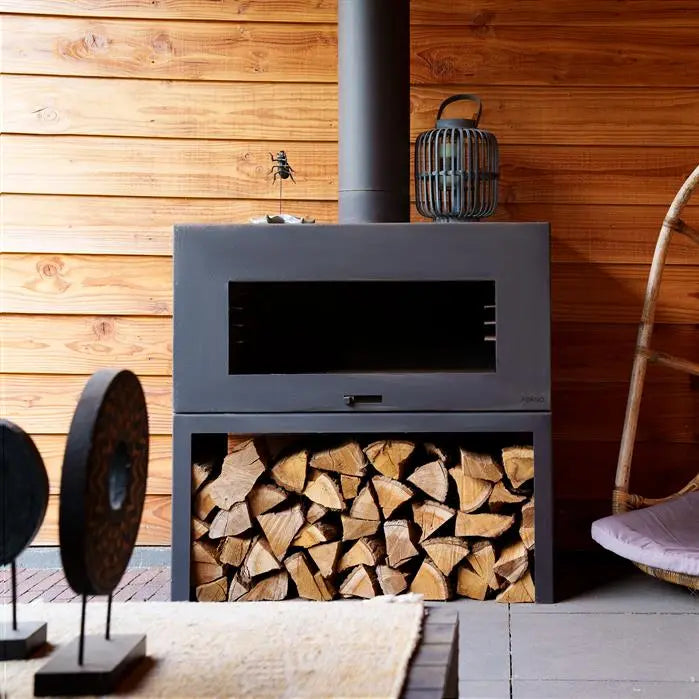 empty back fire place with flue and wood store underneath mounted next to wooden wall