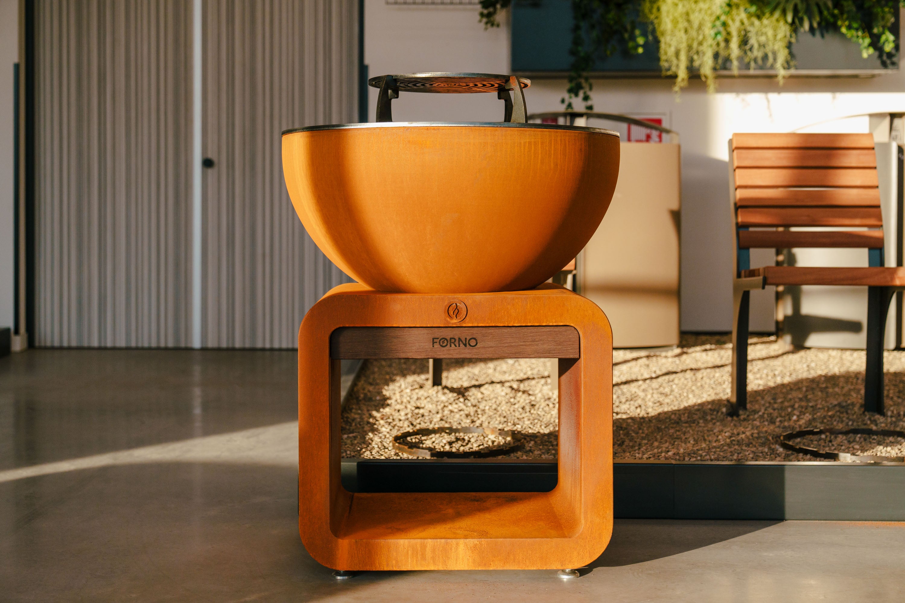 Wooden fire pit with visible branding in an outdoor setting