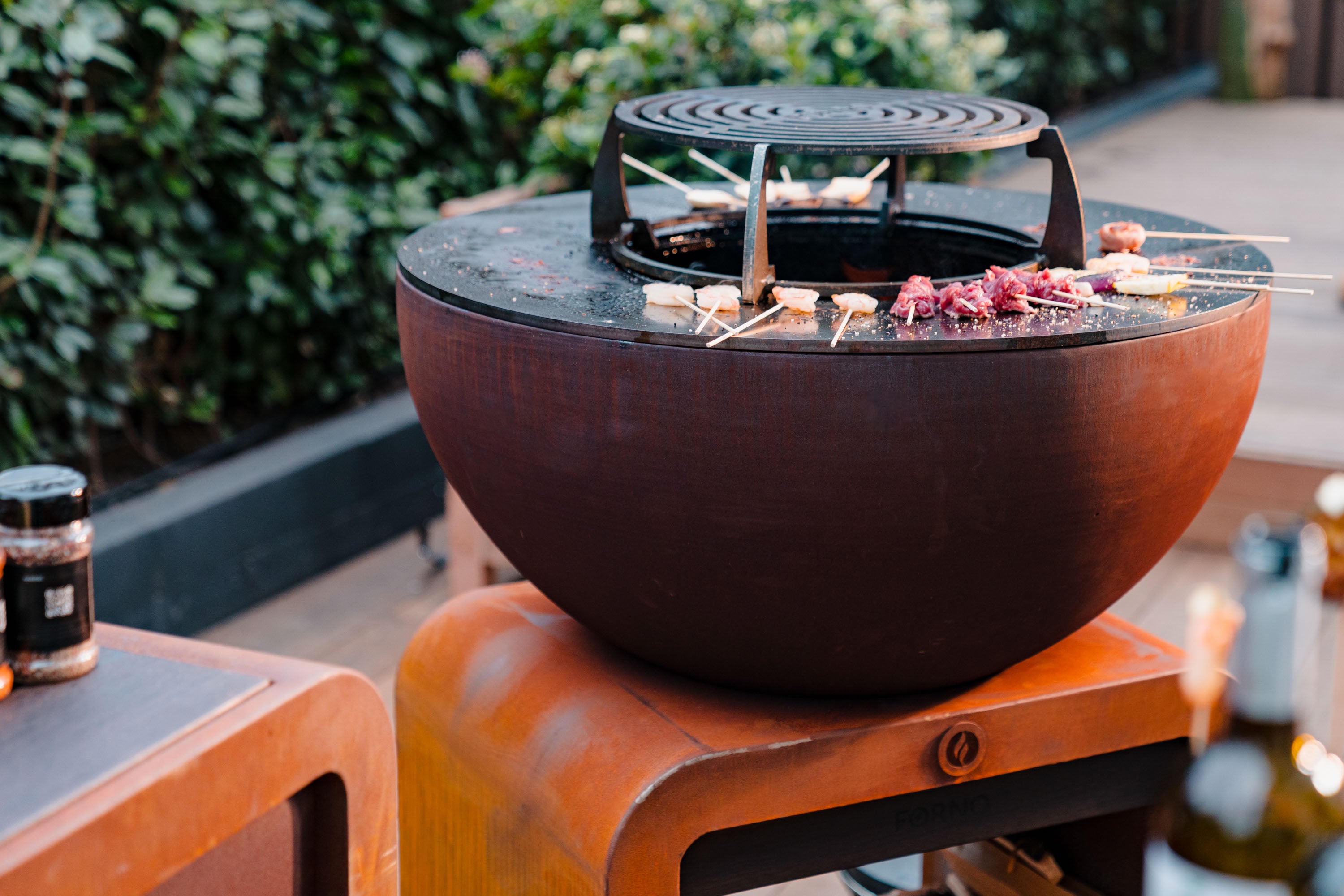 round bbq and grill with skewers of food cooking