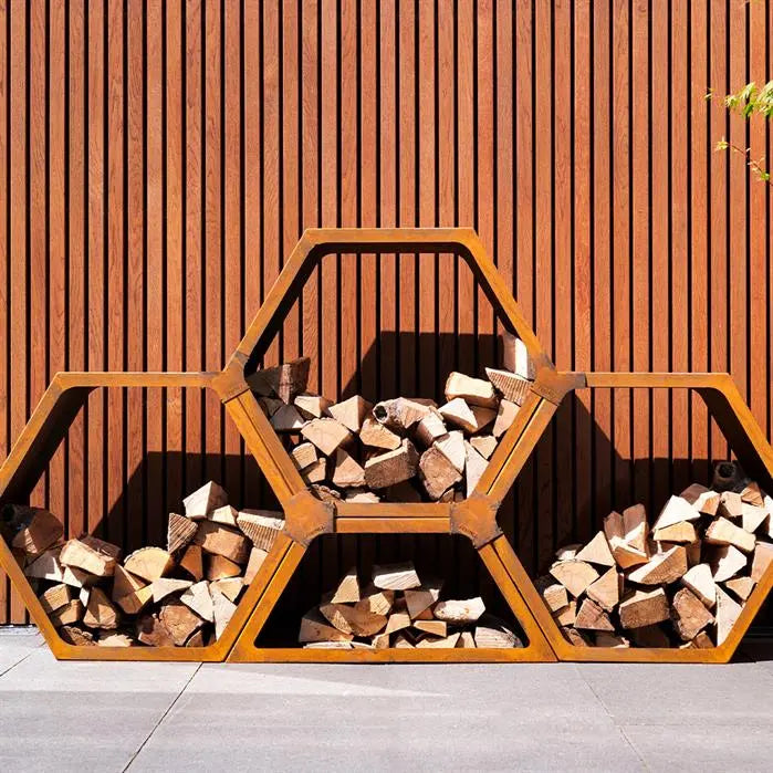 connected hexagonal corten steel wood store filled with wood