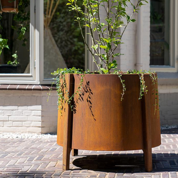 corten steel planter with feet, planted with tree and shrubs
