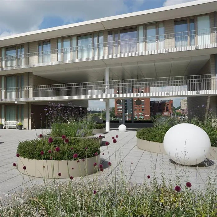 curved retaining walls creating flower beds in public space