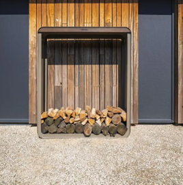 aluminium and bamboo firewood storage box with firewood against a wooden wall.