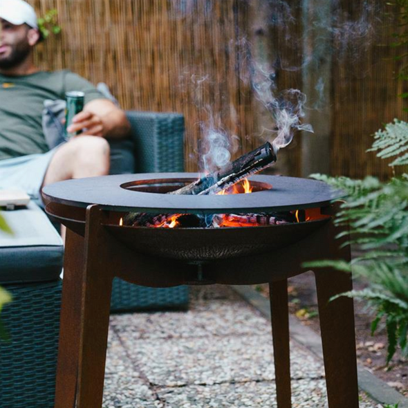 fire table and bbq made from corten steel in use with burning wood