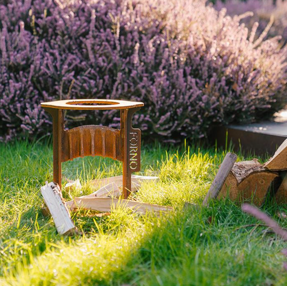 corten steel wood splitting tool in a garden