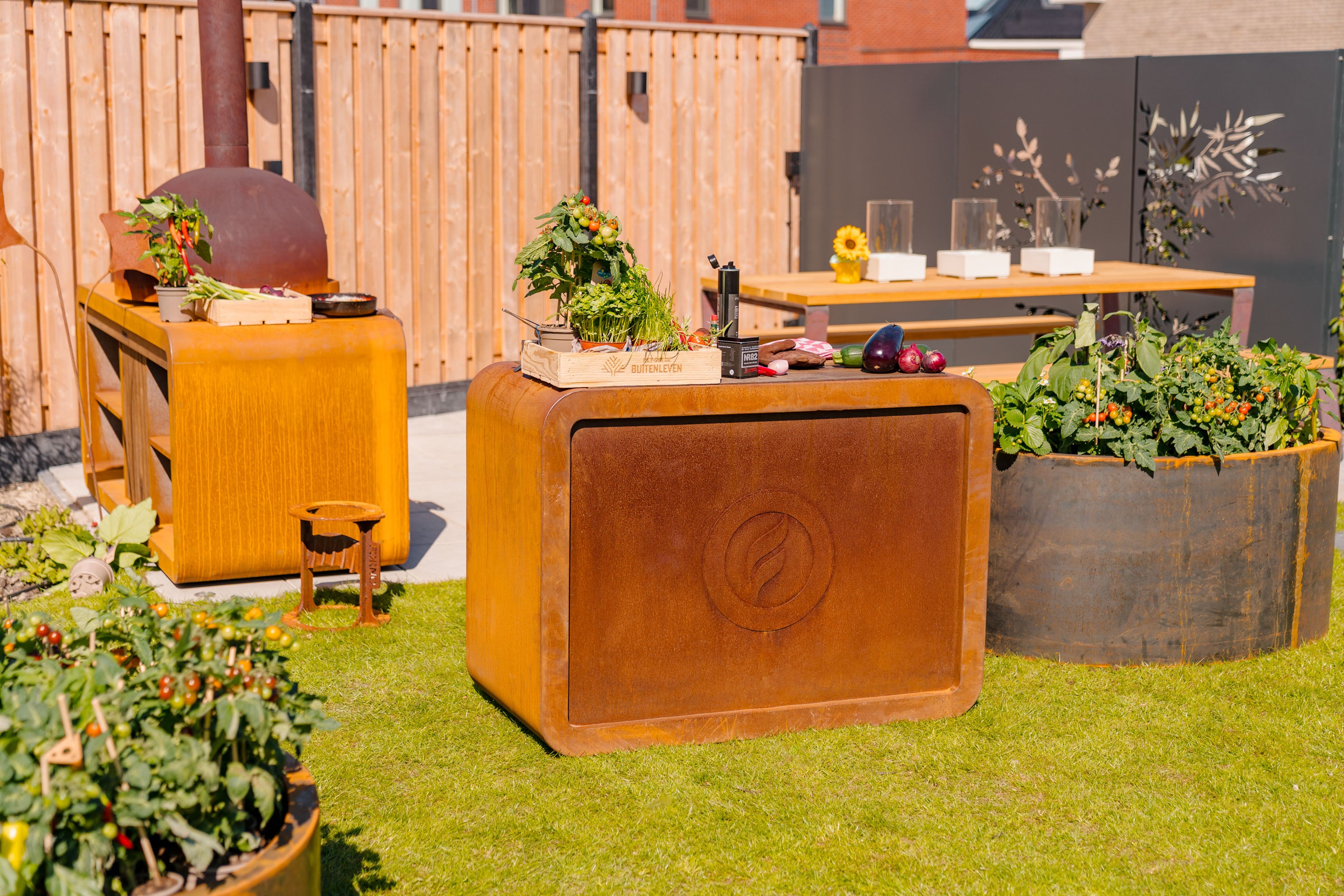 Outdoor kitchen setup with wooden cabinets, grill, and plants in a garden.