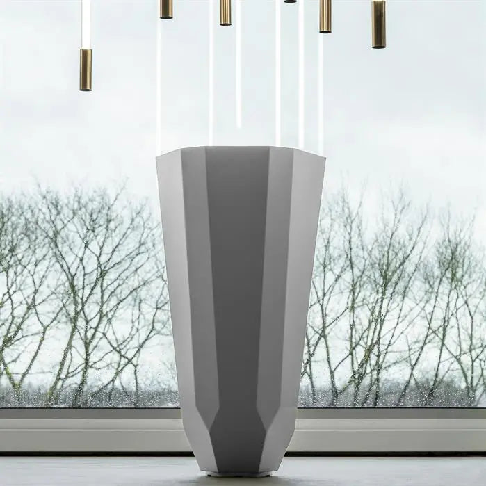 tall geometrical planter with modern lights above