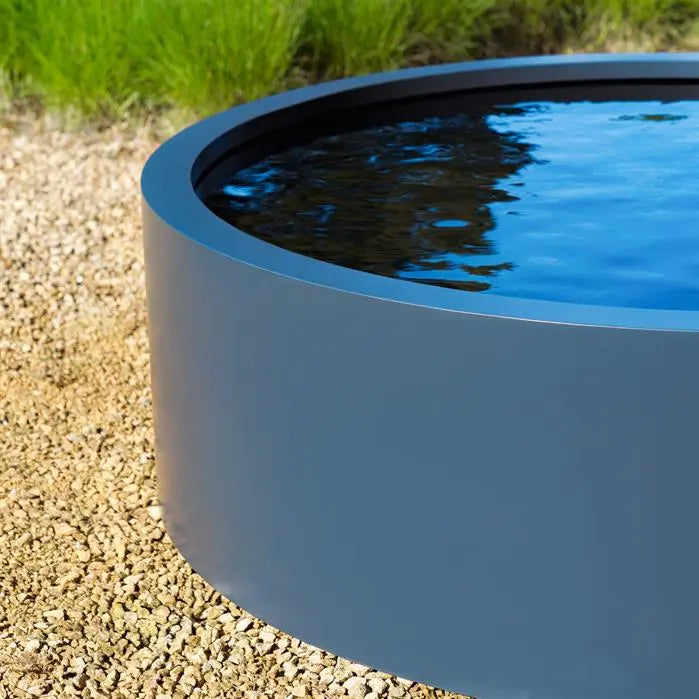 detail of a black round aluminium pond