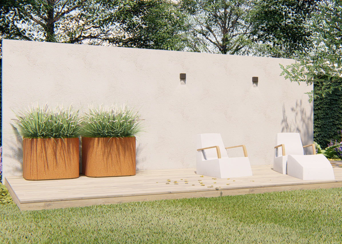 two corten planters with plants against a plain wall on decking next to two sun loungers