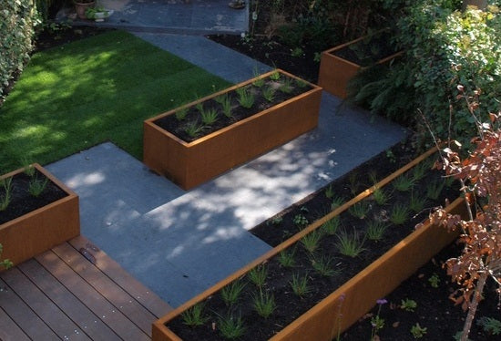 corten steel troughs planted up in a variety of sizes