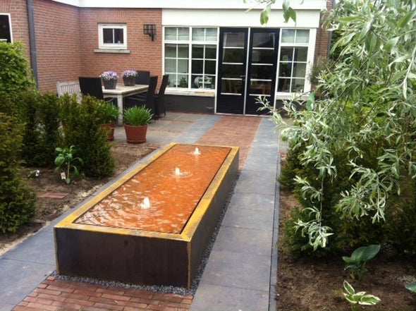 rectangular corten steel water table filled with water