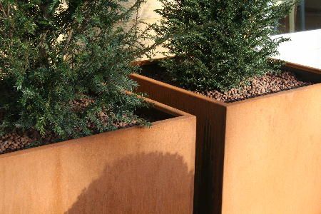 two tall corten garden planters next to each other