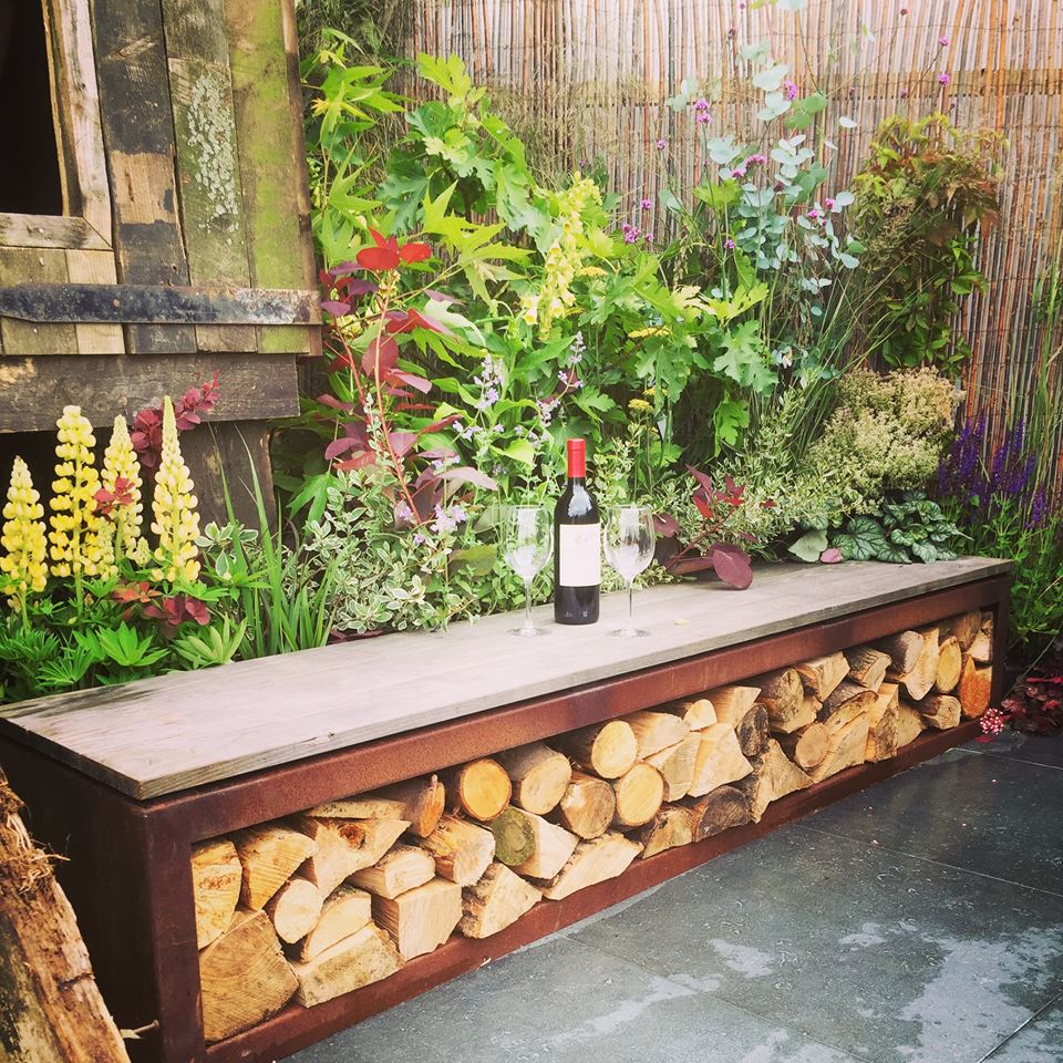 corten steel wood store bench filled with wood