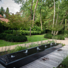 rectangular black aluminium water table filled with water and with small fountains