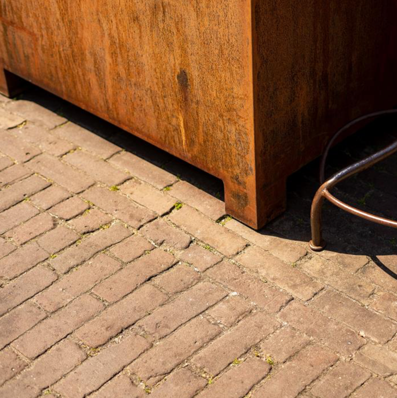 detail of a corten steel planters with feet