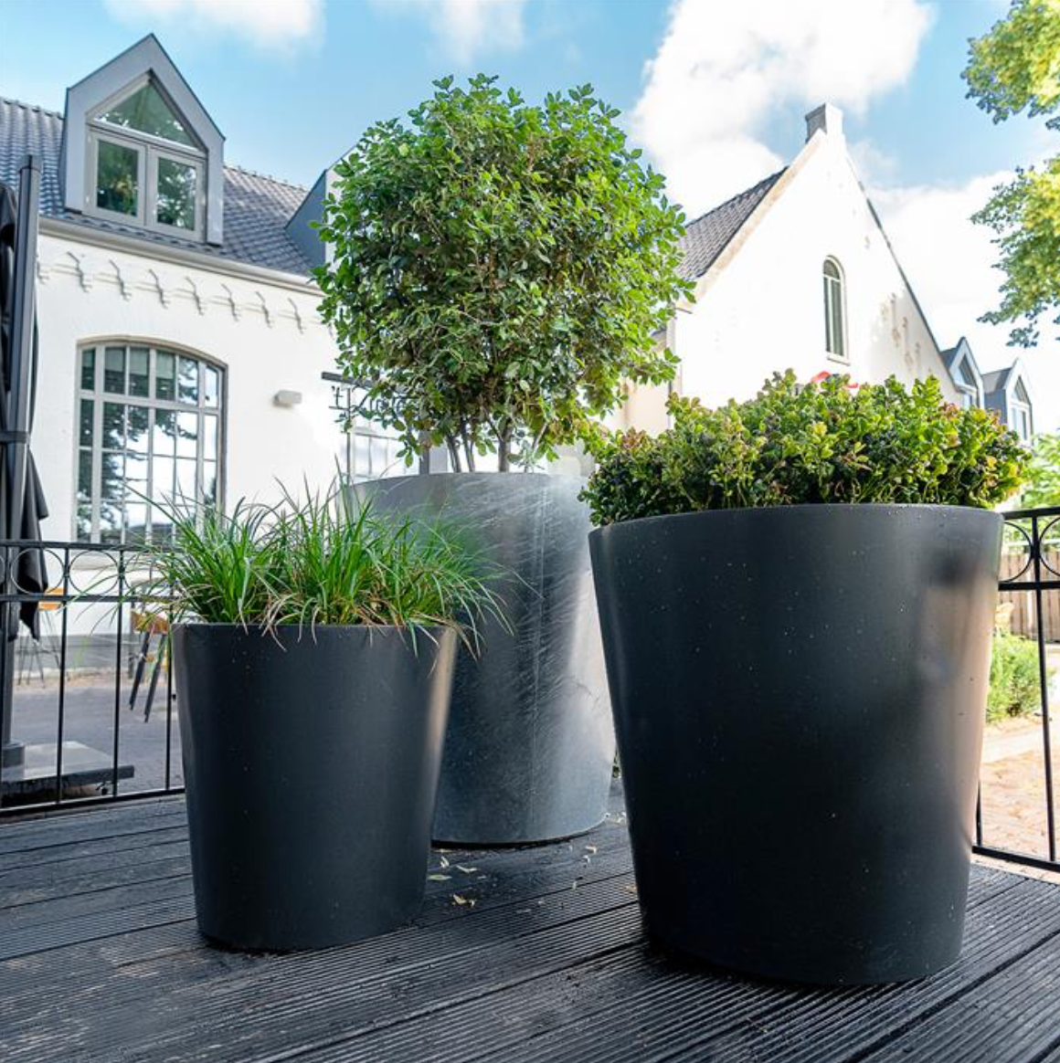 three black aluminium garden planter's of different sizes on decking