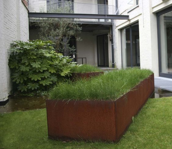 corten steel trough planted with grass