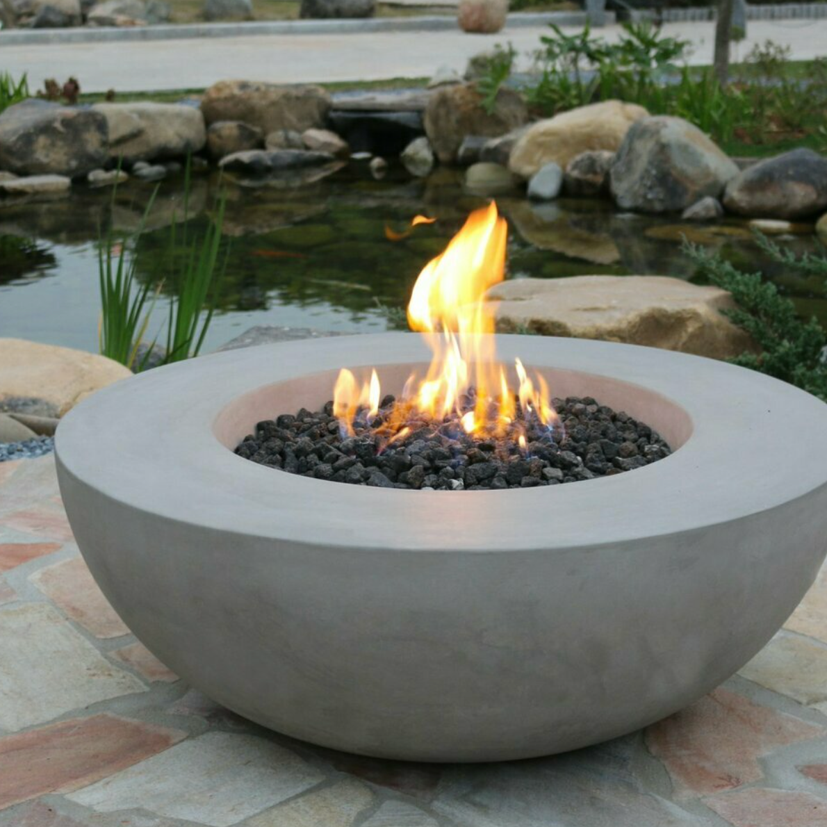 large round grey gas fire bowl alight