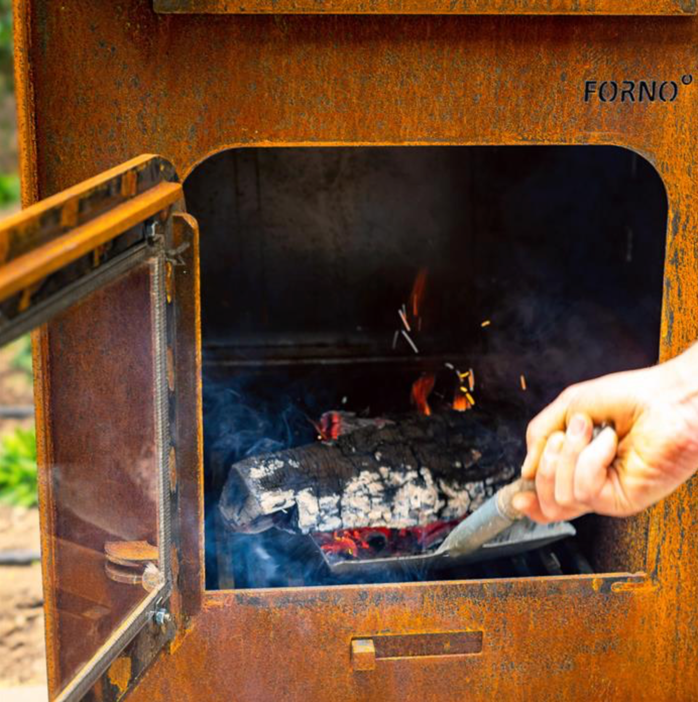 Corten steel outdoor fireplace with open door