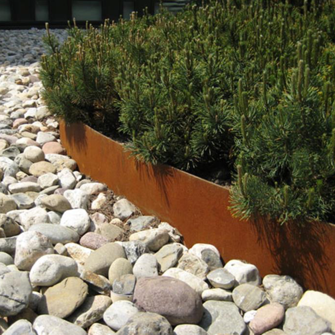 corten steel with straight edges surrounding flower bed