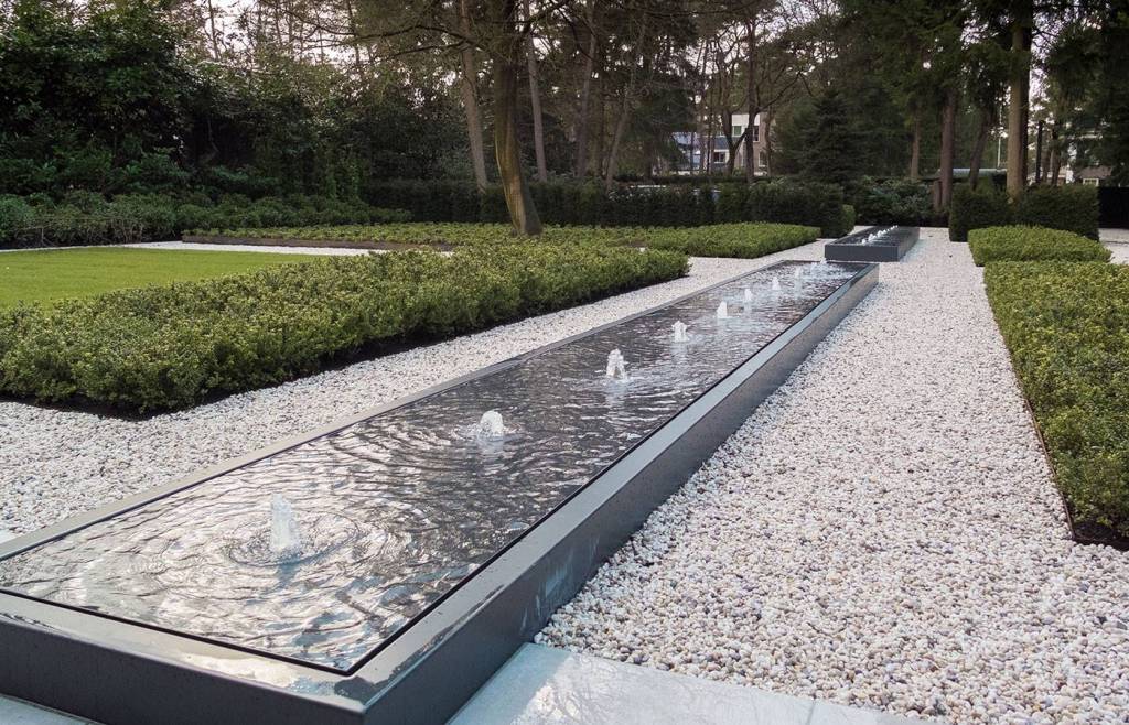 two long black aluminium water tables filled with water and fountains